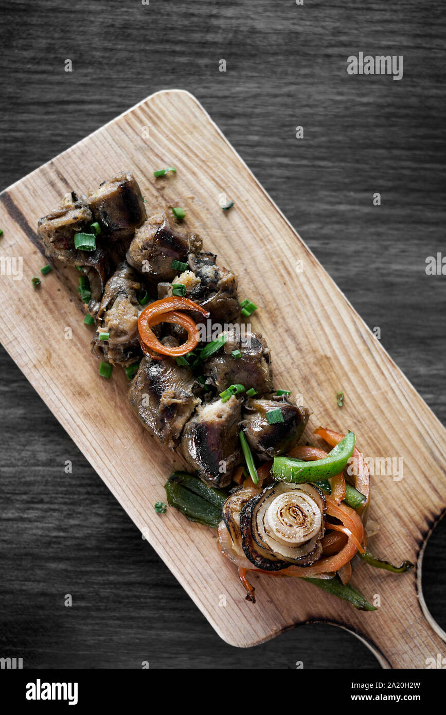grilled fresh sausage starter tapas snack set on rustic wood board Stock Photo