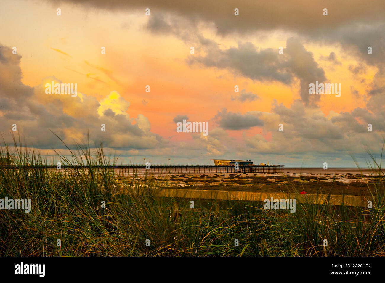 Southport, Merseyside, UK. 30th September, 2019. UK Weather; Stormy clouds & a bright colourful start to the day. Three flood warnings have been issued for the north-west with deteriorating conditions up to noon when up to 3 inches of rain is forecast. Credit: MediaWorldImages/AlamyLiveNews. Credit: MediaWorldImages/Alamy Live News Stock Photo