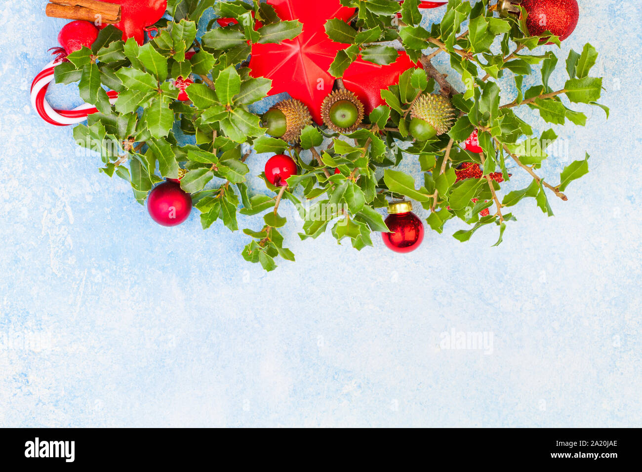 Christmas background with green holly leaves, red berries and Xmas ...
