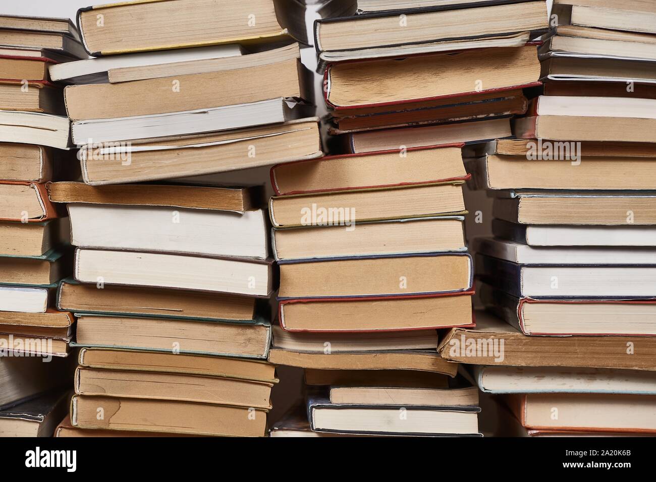 Wall of books piled up Stock Photo