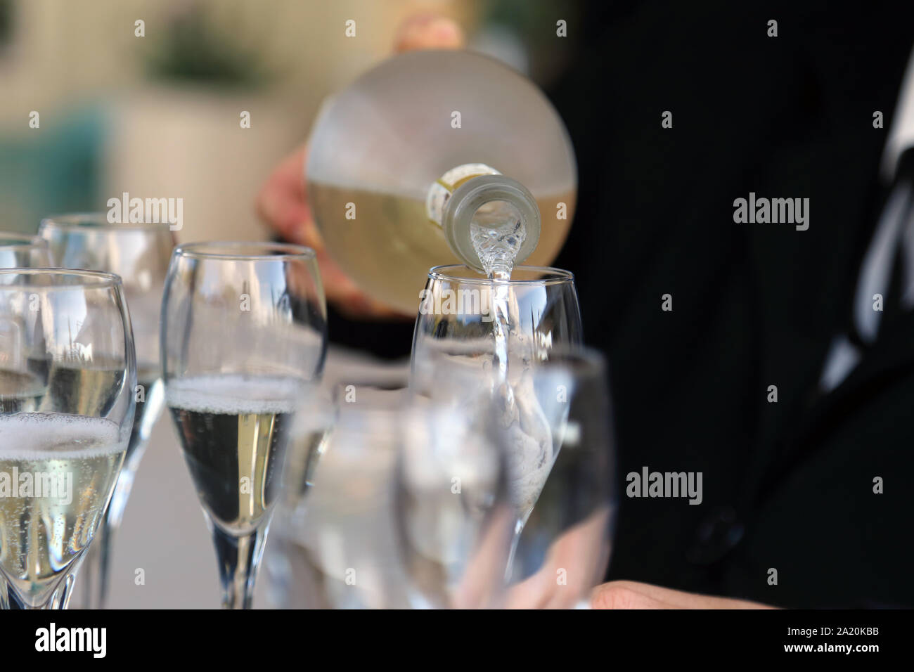 Glass glasses with prosecco - setting up the glasses on the table in the restaurant for an aperitif Stock Photo