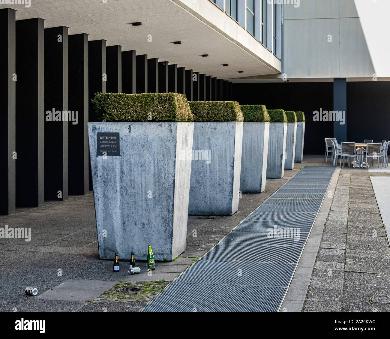 The Deutsche Oper Berlin in modern building designed by architect Fritz Bornemann.Topiary bushes in planters and outdoor tables of cafe Stock Photo