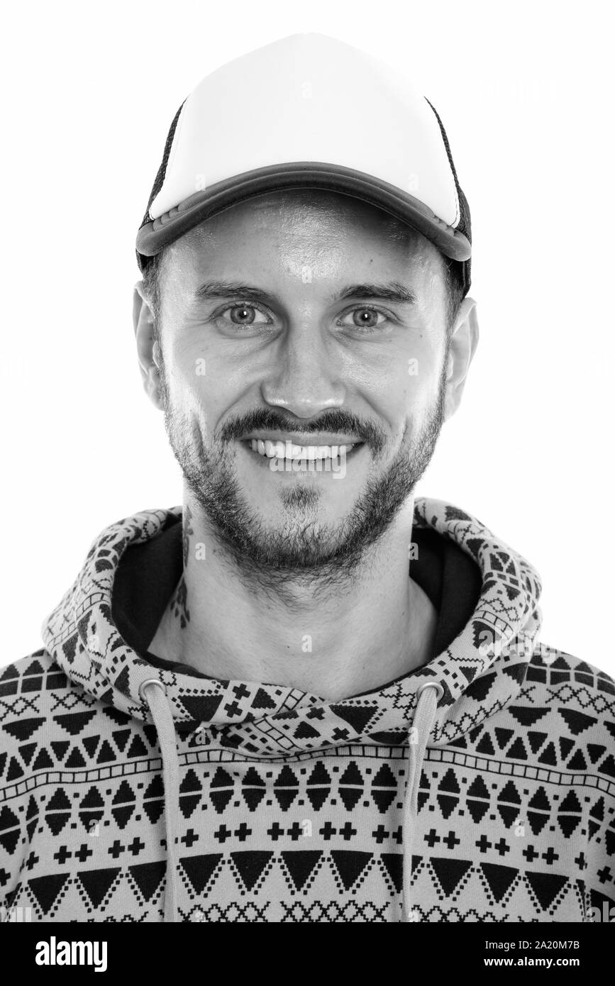 Face of happy young man smiling while wearing hat Stock Photo