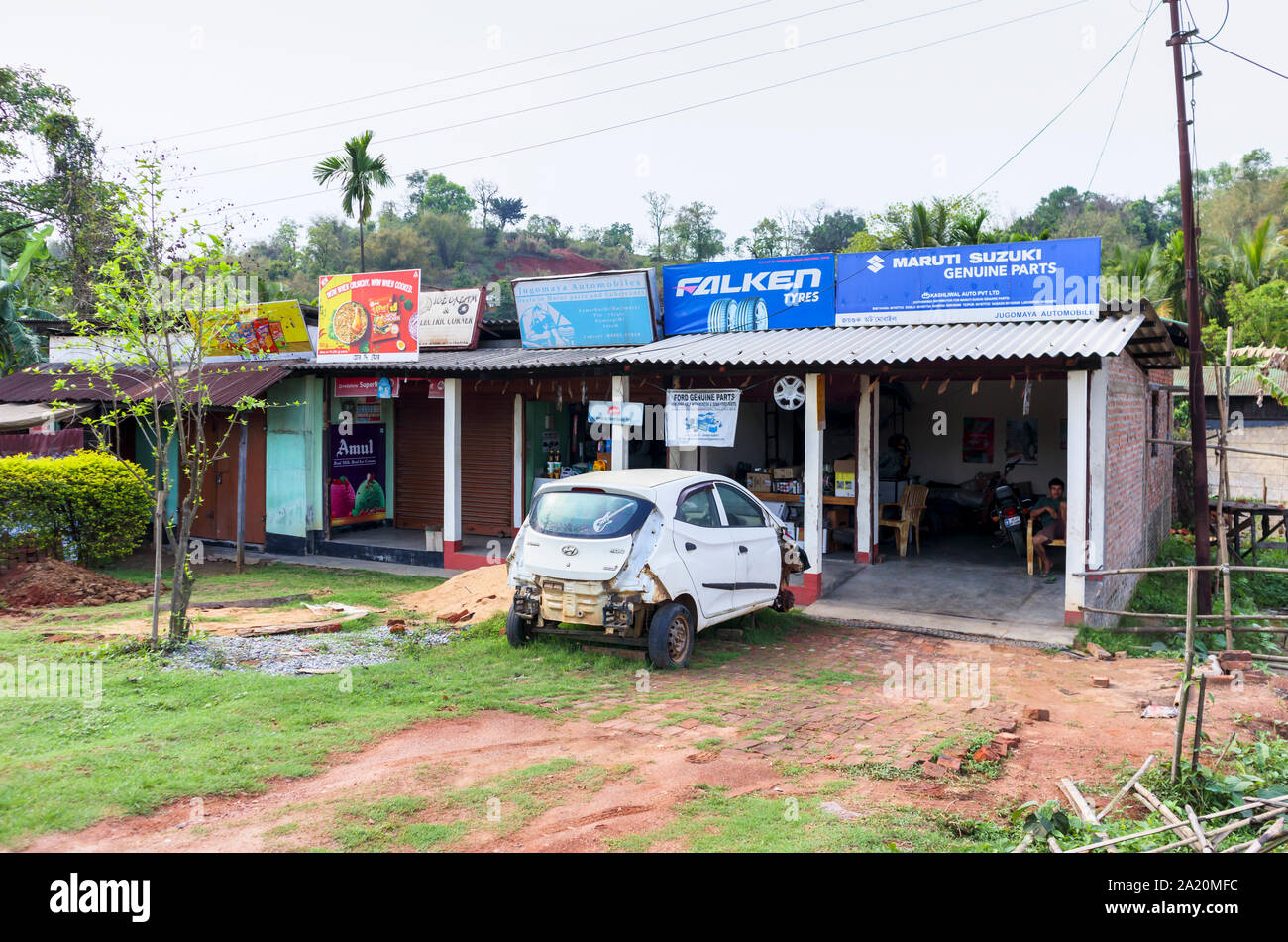 Roadside crashed Hyundai Eon car in a garage under repair, Kamarkuchi, a village in Kamrup District, western Assam, northeast India Stock Photo