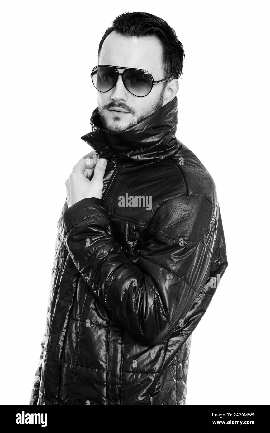 Studio shot of cool young man holding leather jacket Stock Photo