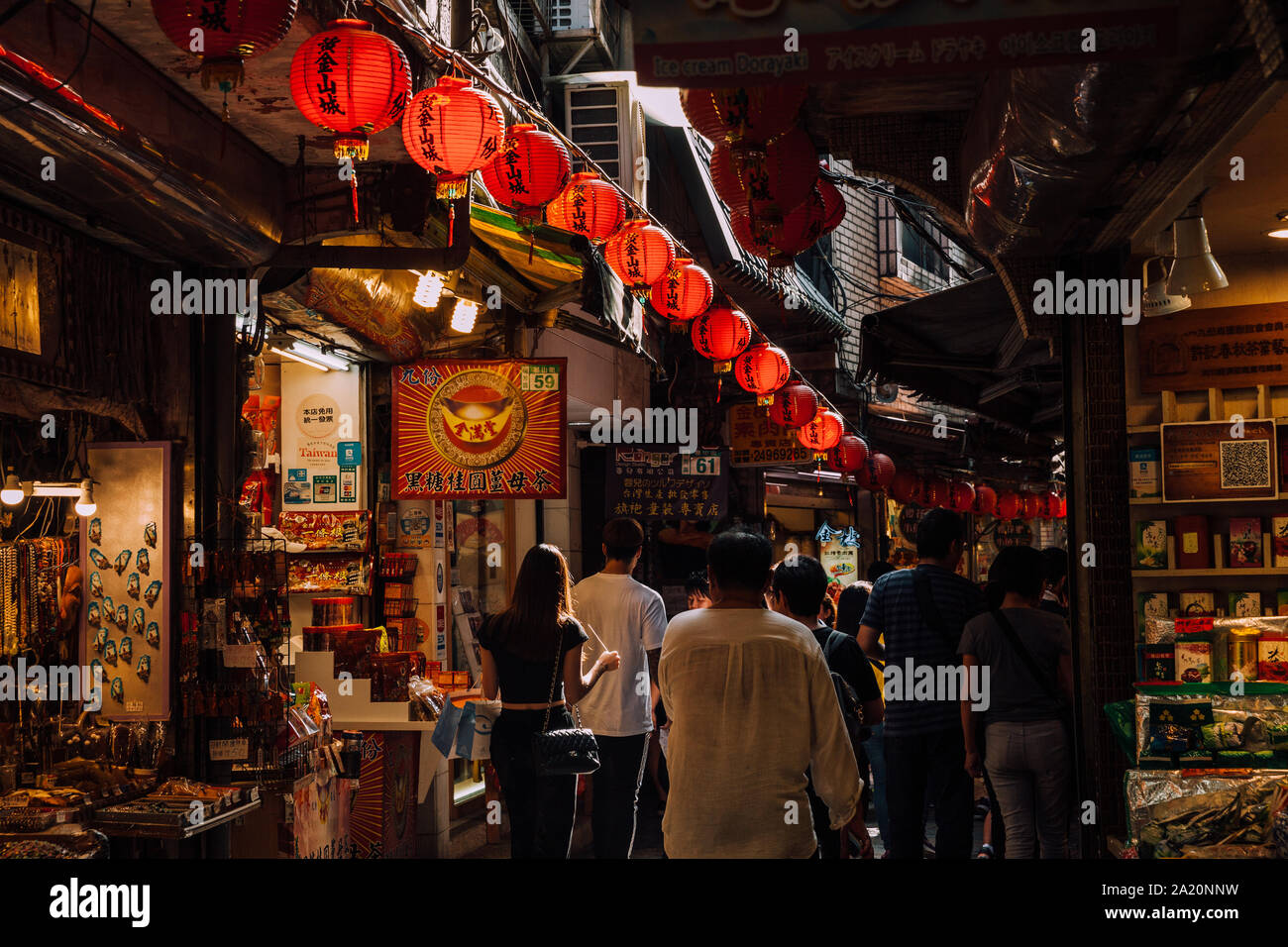 Jiufen, Taiwan - November 07, 2018: A young woman walks in the crowd at the Old Street market on November 7, 2018, in Jiufen, Taiwan Stock Photo