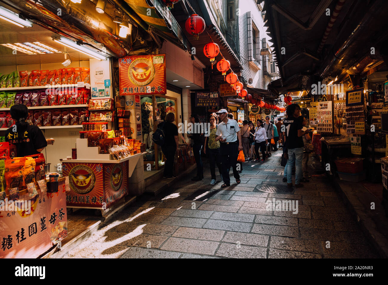Jiufen, Taiwan - November 07, 2018: People walk with purchases along the Old Street market on November 7, 2018, in Jiufen, Taiwan Stock Photo
