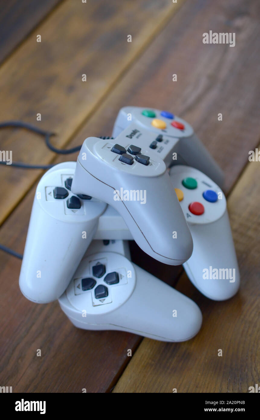 KHARKOV, UKRAINE - SEPTEMBER 18, 2019: Dendy video game console classic controllers on a wooden table. One of the most classic gaming consoles Stock Photo