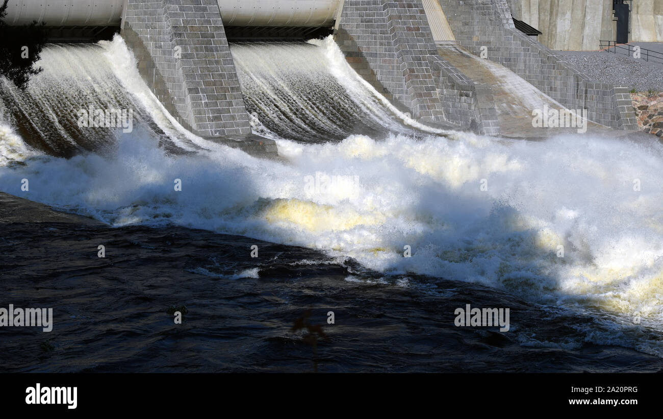 Hydroelectric power station dam sluice gate open. Panorama view. Stock Photo