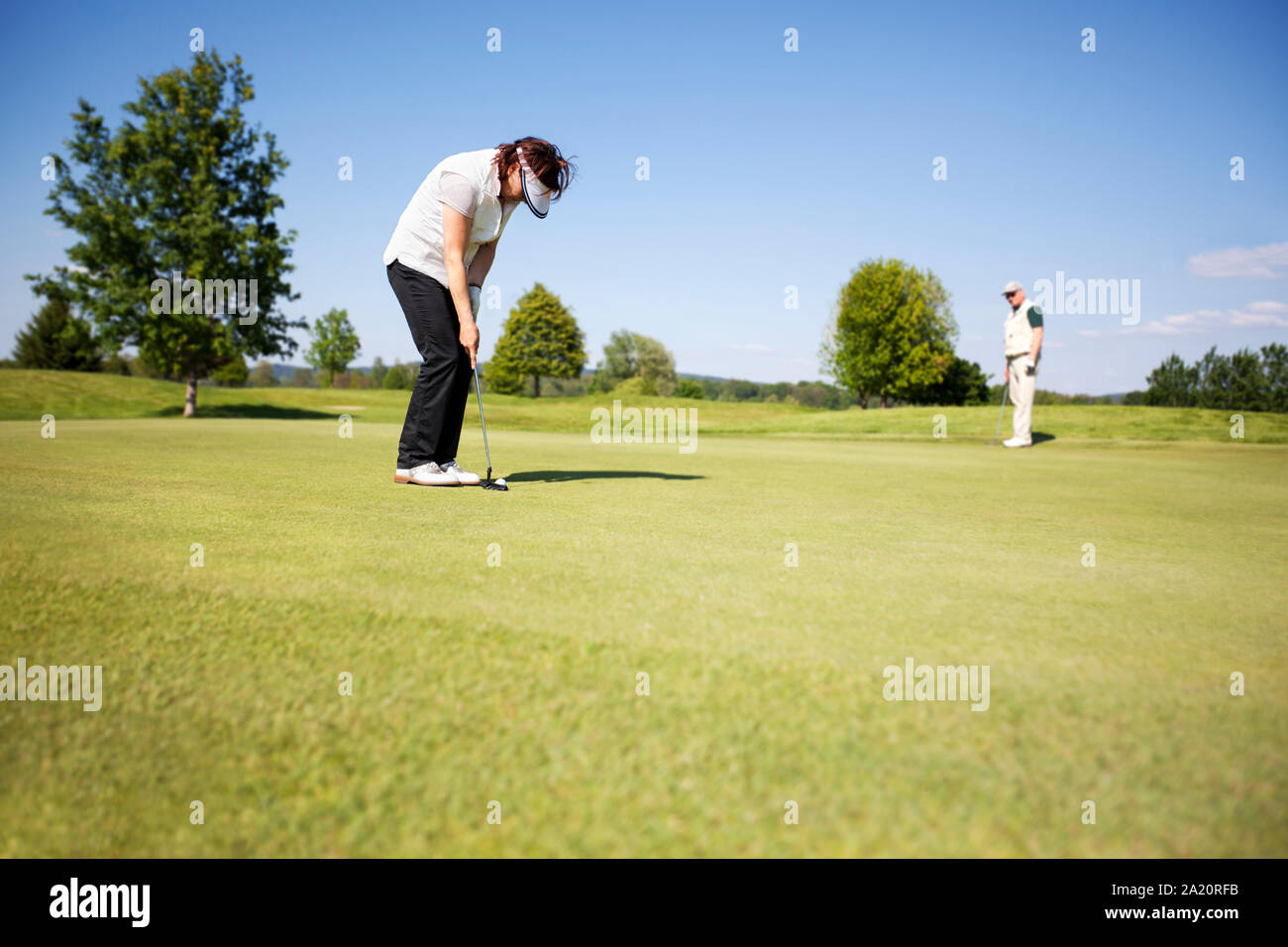 Two senior golf player on green. Stock Photo