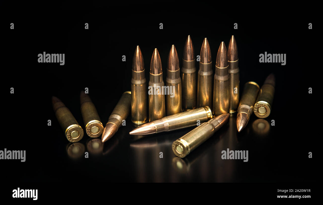 Bullet isolated on black background with reflexion. Rifle bullets close-up on black back. Cartridges for rifle and carbine on a black. Stock Photo