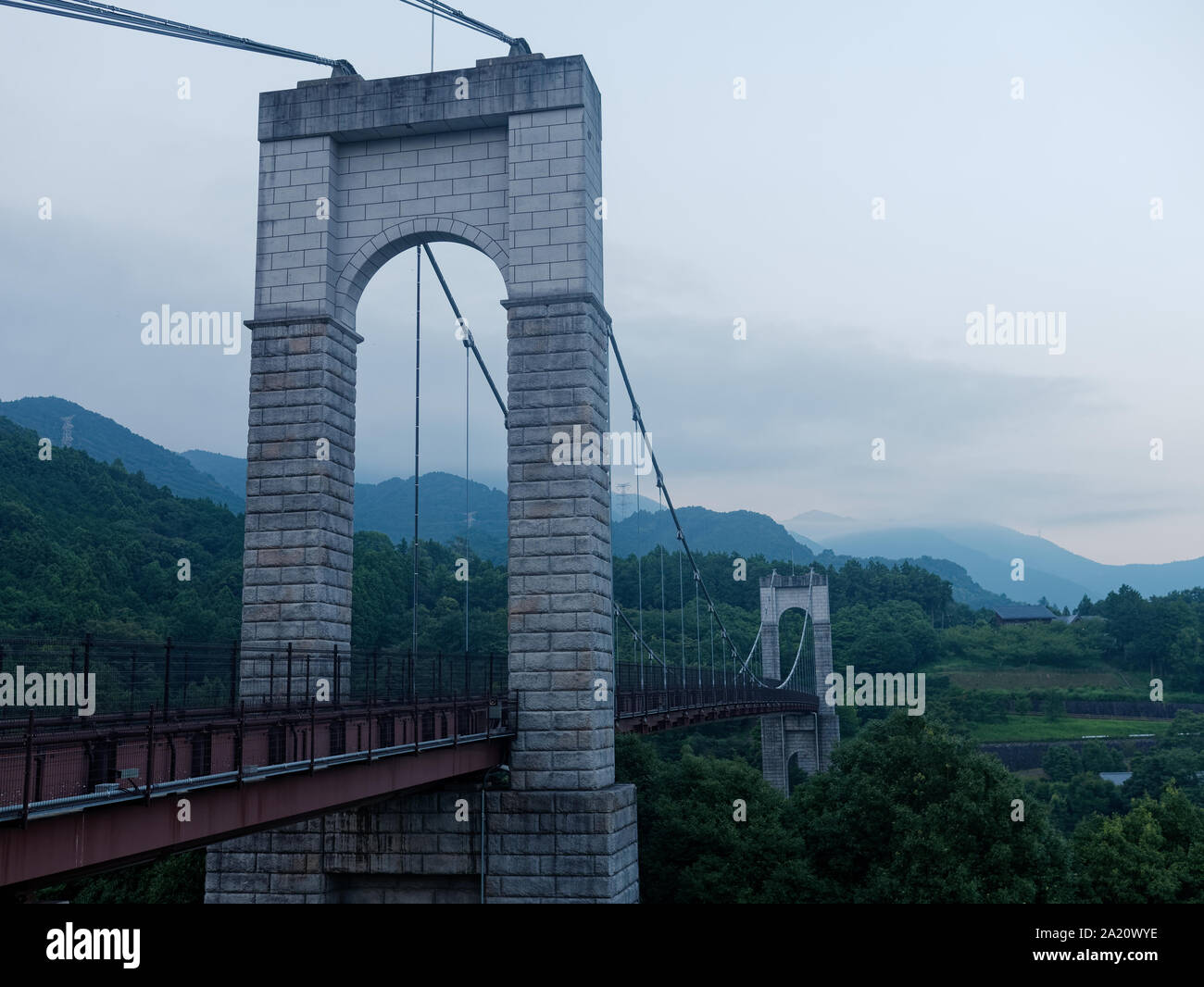 Suspension bridge in the forest at dusk. Photographed at Hadano Togawa