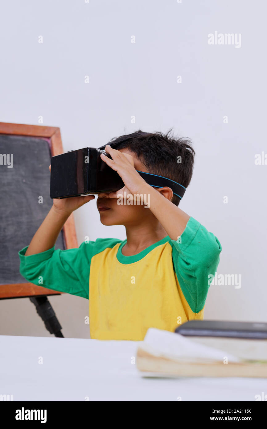 Excited kid using e-learning with VR glasses Stock Photo
