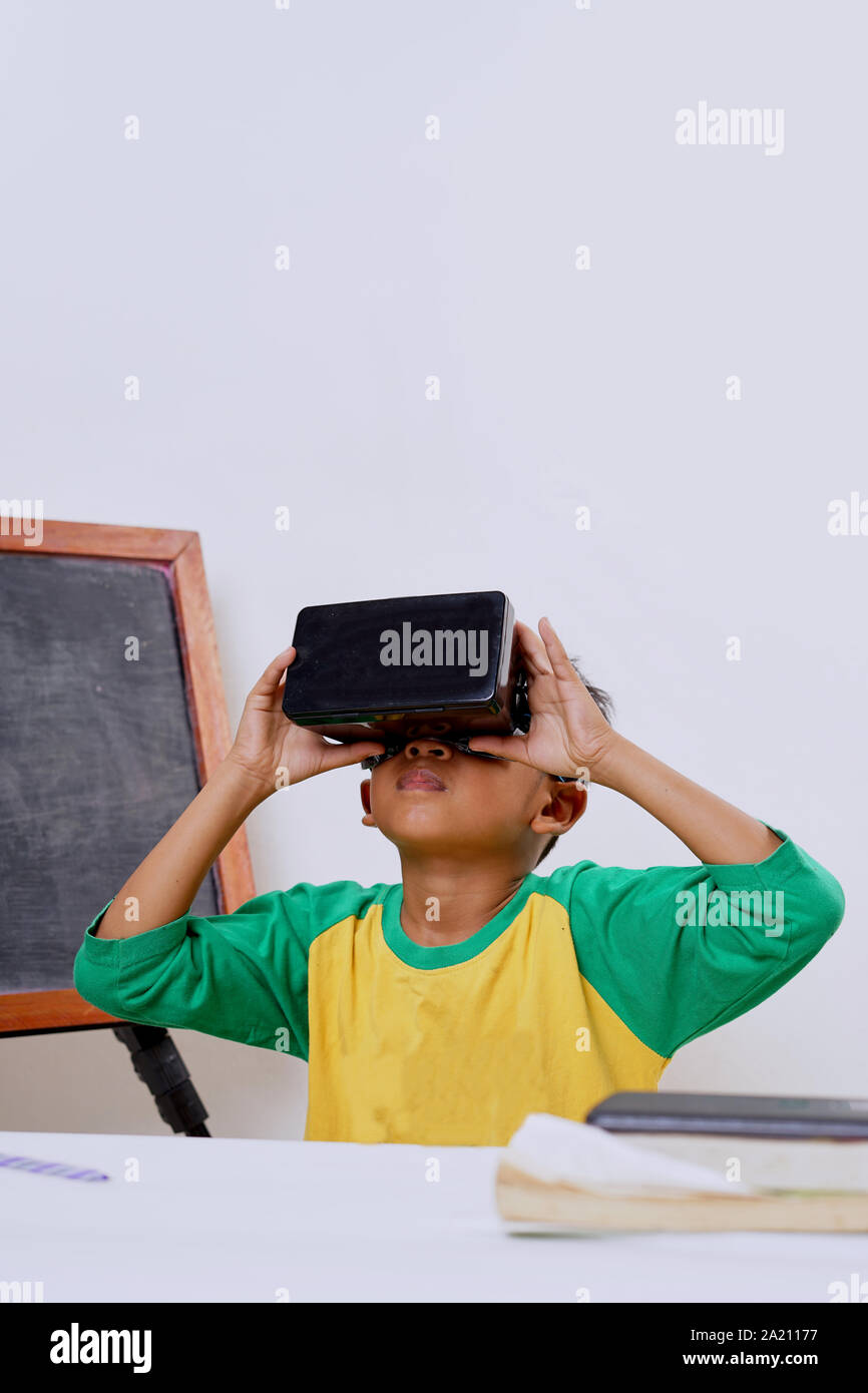 Excited kid using e-learning with VR glasses Stock Photo