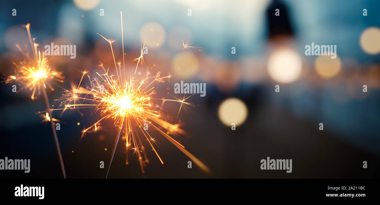 Burning sparkler with bokeh light background Stock Photo