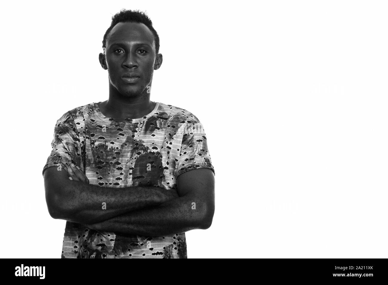 Young black African man with arms crossed Stock Photo - Alamy