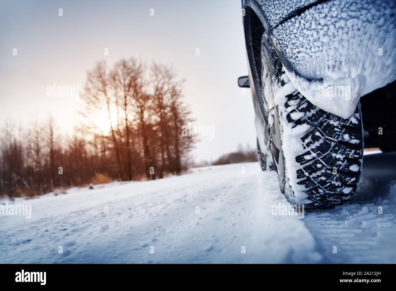 Car tires on winter road covered with snow Stock Photo - Alamy