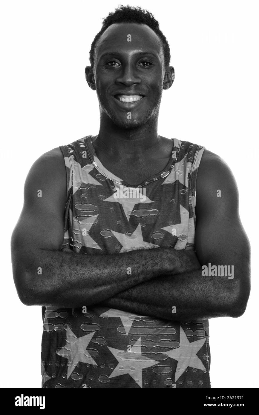 Young happy black African man smiling with arms crossed Stock Photo - Alamy