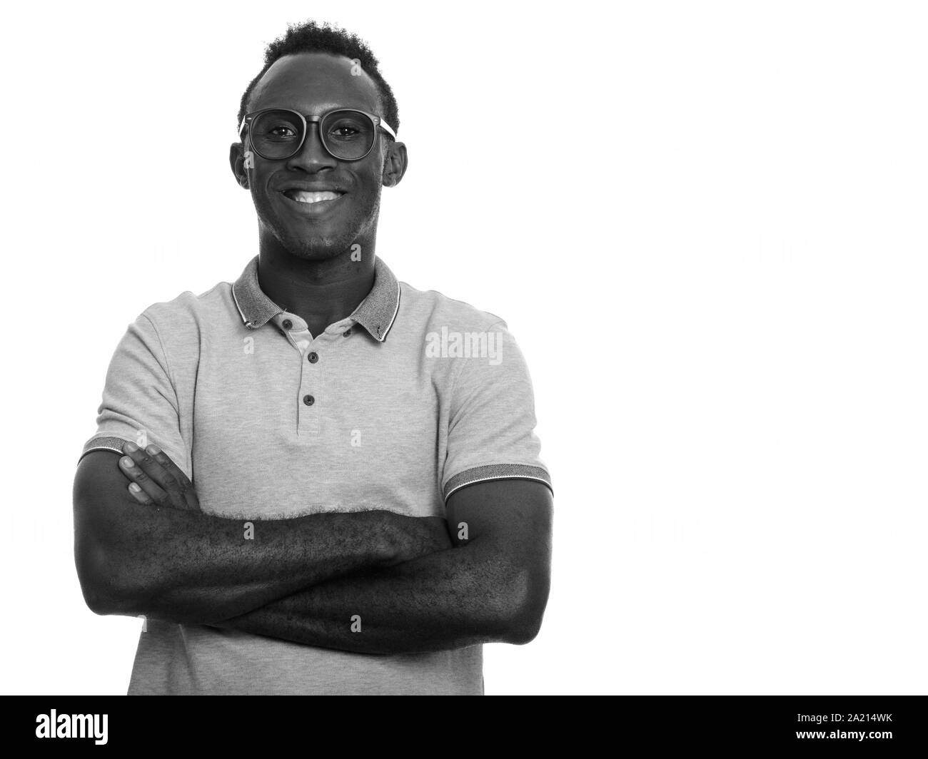 Young happy black African man smiling with arms crossed Stock Photo - Alamy