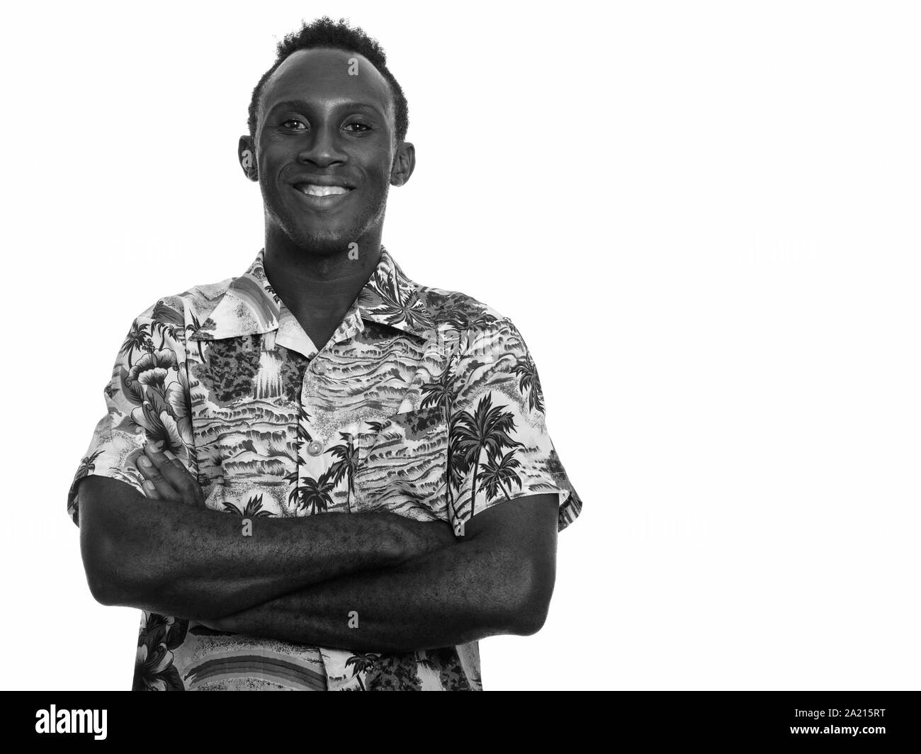 Young happy black African man smiling with arms crossed Stock Photo - Alamy