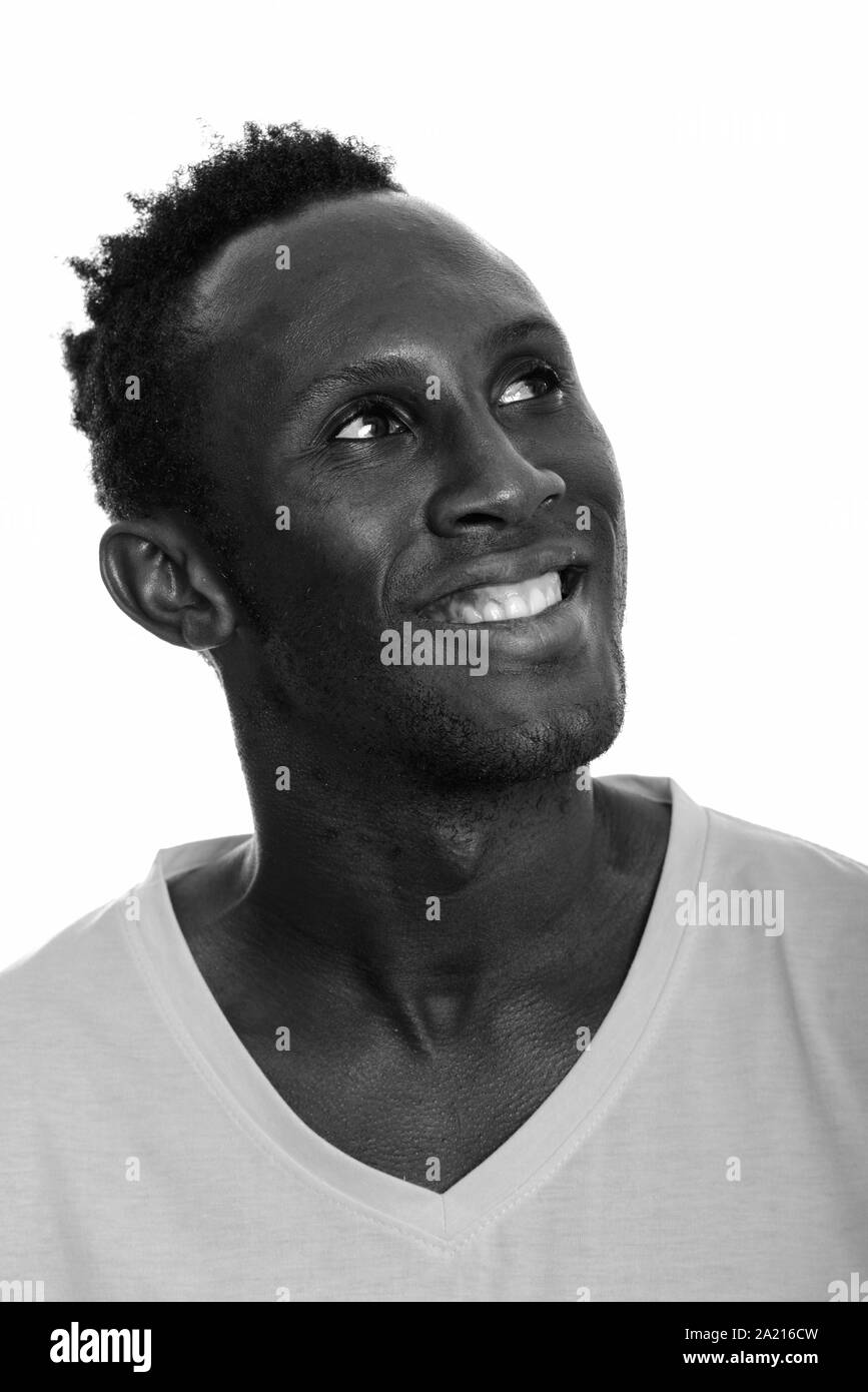 Face of young happy African man smiling and thinking Stock Photo - Alamy