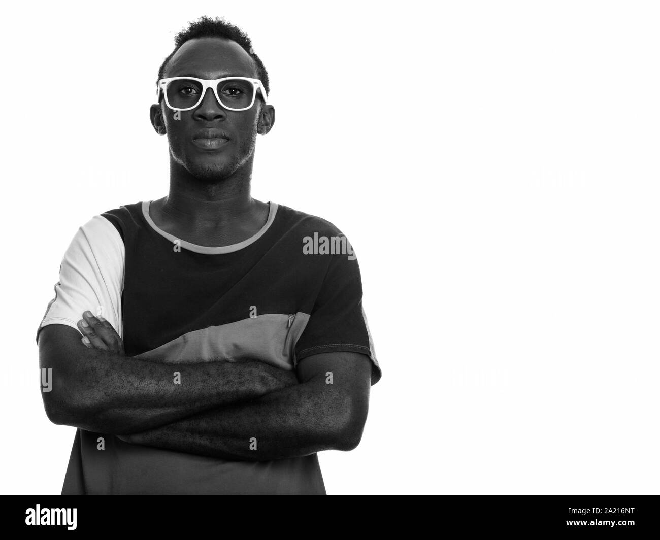 Young black African man with arms crossed Stock Photo - Alamy