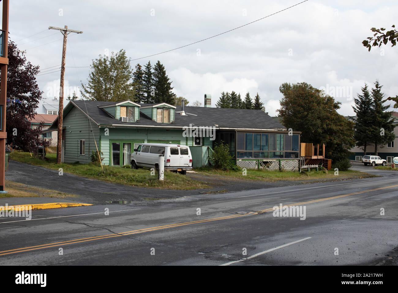 typical wooden house with van in front of the house in Alaska Stock Photo
