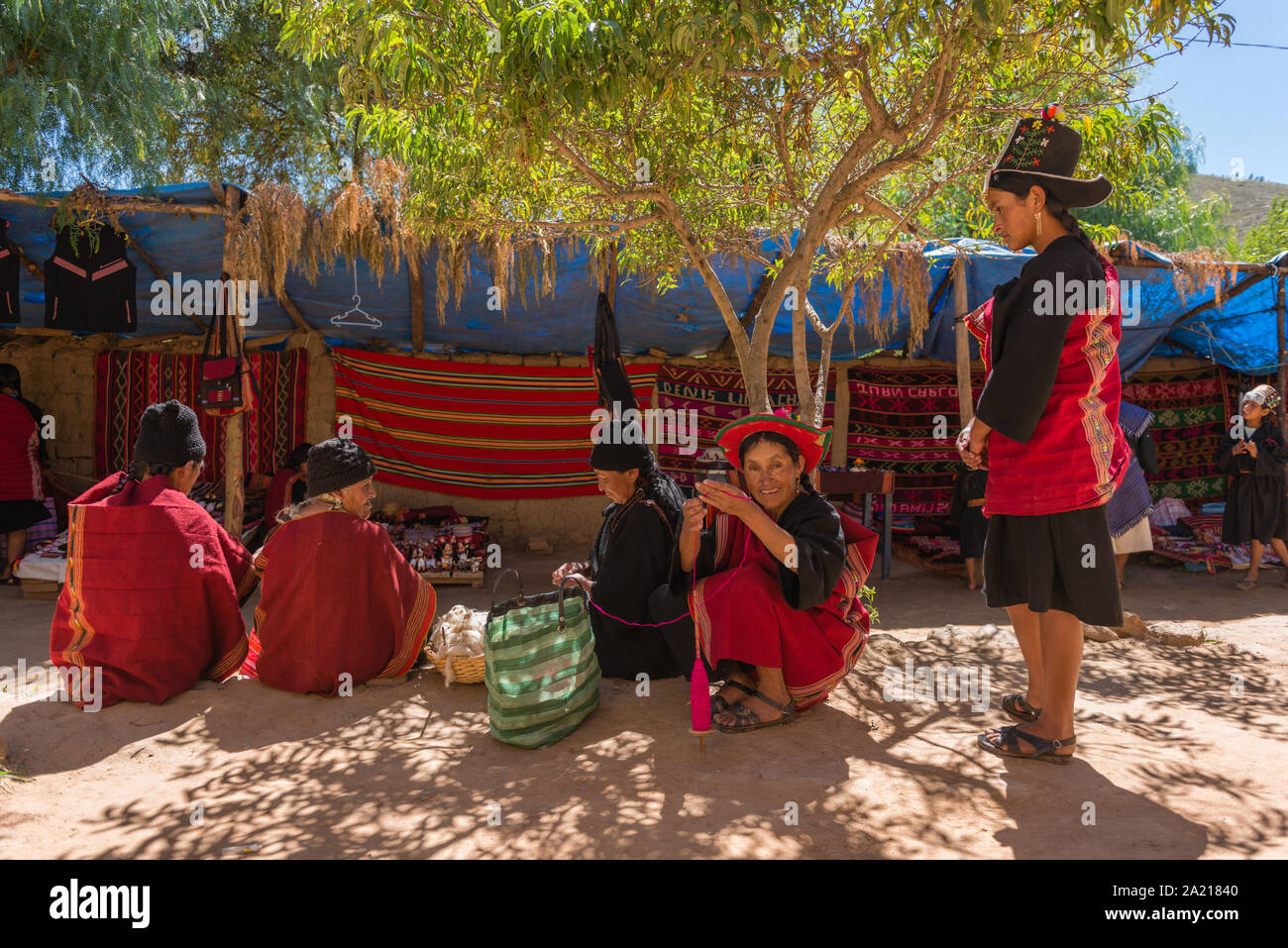 Women sitting, talking and knitting, indigenous village of Puka Puka near Tarabuco, meeting indigenous Quechuan people, Sucre, Bolivia, Latin America Stock Photo