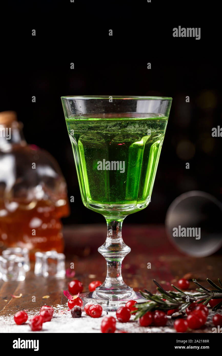 Absinthe Def green cocktail on the basis of absinthe in a stylish vintage glass on a ...