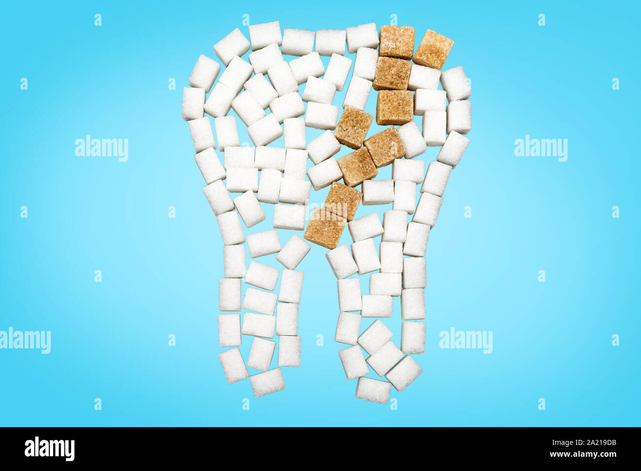 Tooth decayed tooth in front of blue background Stock Photo - Alamy
