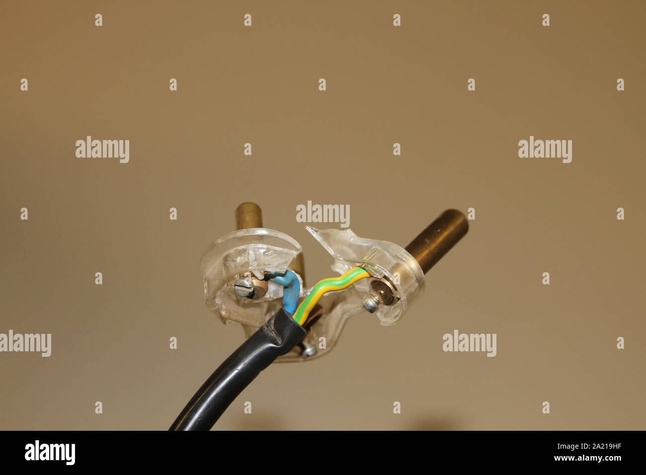 Broken 3-pin plug against cream background, South Africa. Stock Photo