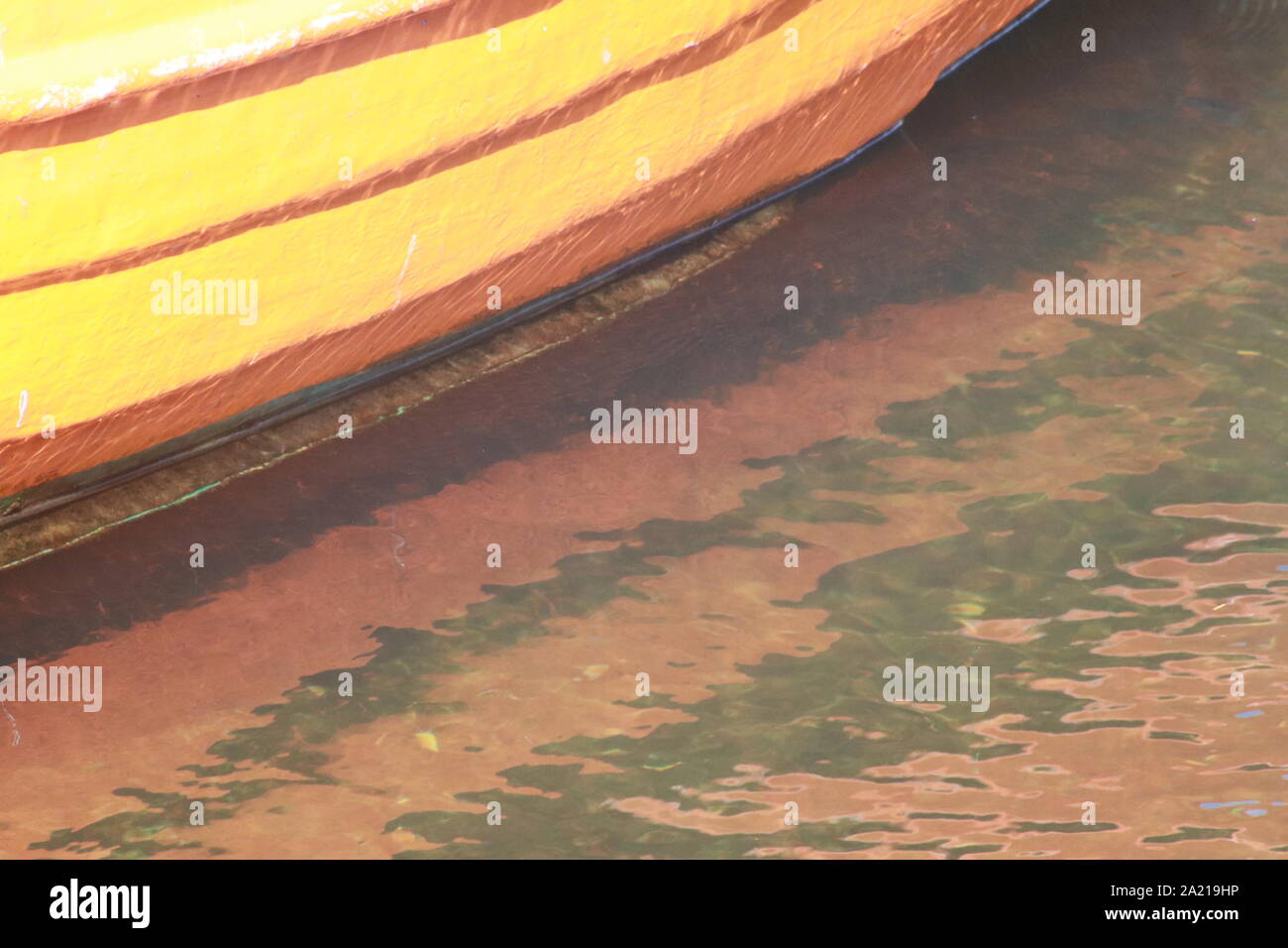 Fishing boats reflected in water of harbour Stock Photo - Alamy