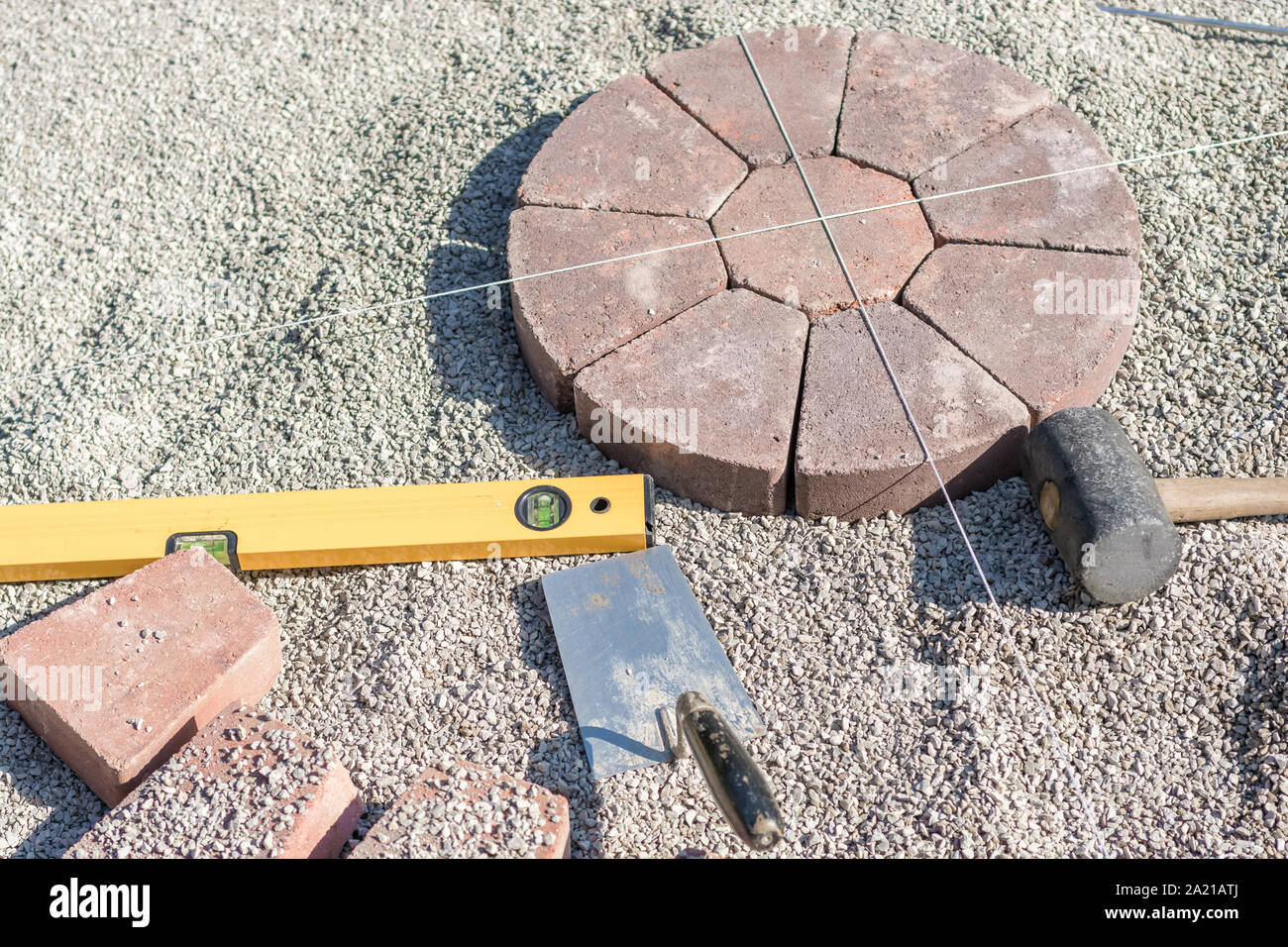 Laying a plaster circle with spirit level and trowel Stock Photo Alamy