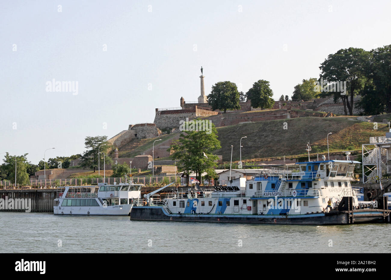 Floating restaurant and bar boat as seen on the confluence of the Sava and Danube Rivers with The Pobednik (Victor) statue monument in the Kalamegdan Park in the background, Belgrade, Serbia. Stock Photo
