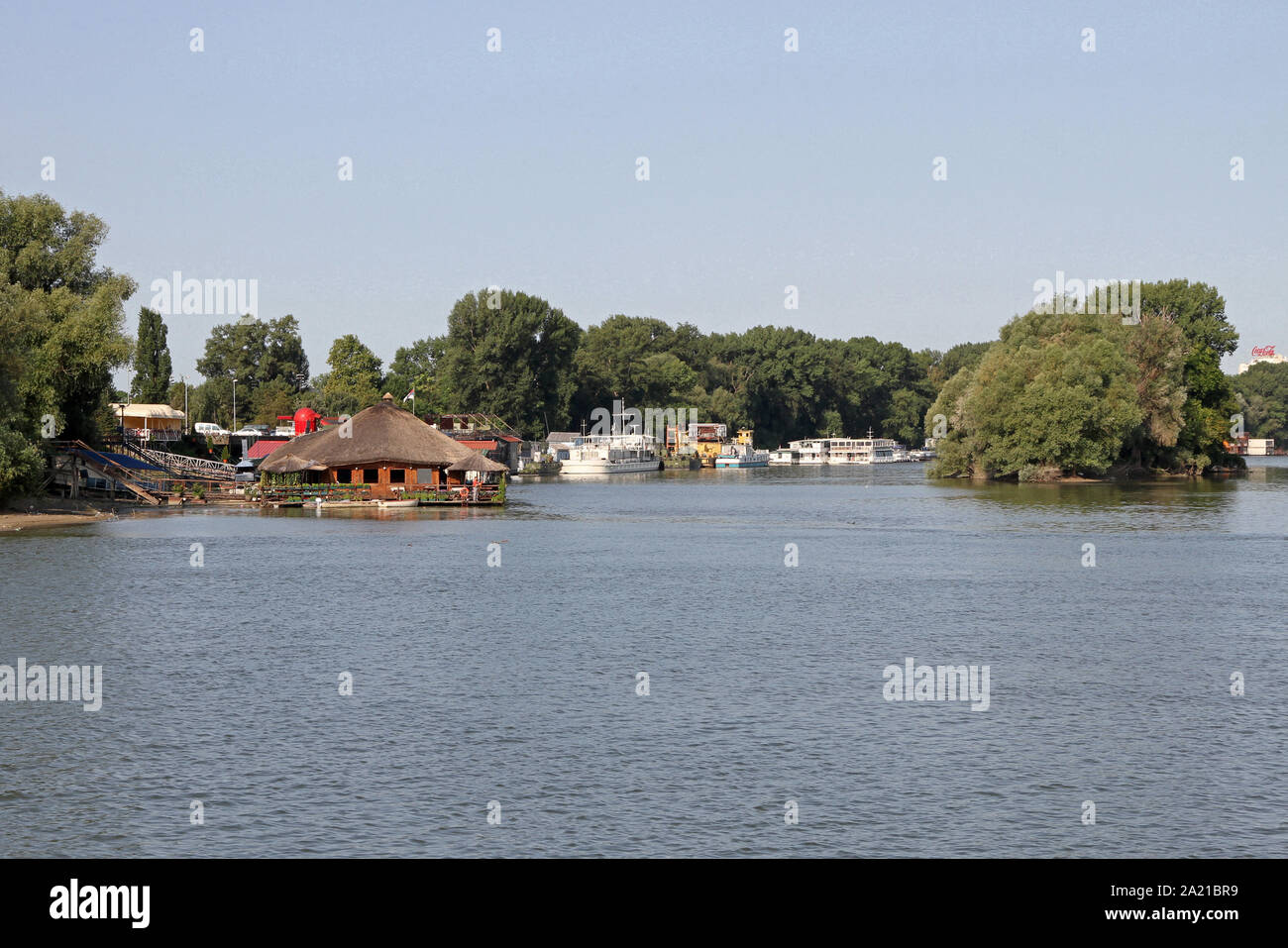 View of entrance to Veliko Ratno Ostrvo (Great War Island) and restaurant-bar boats on the Danube-Sava Rivers confluence, Belgrade, Serbia. Stock Photo
