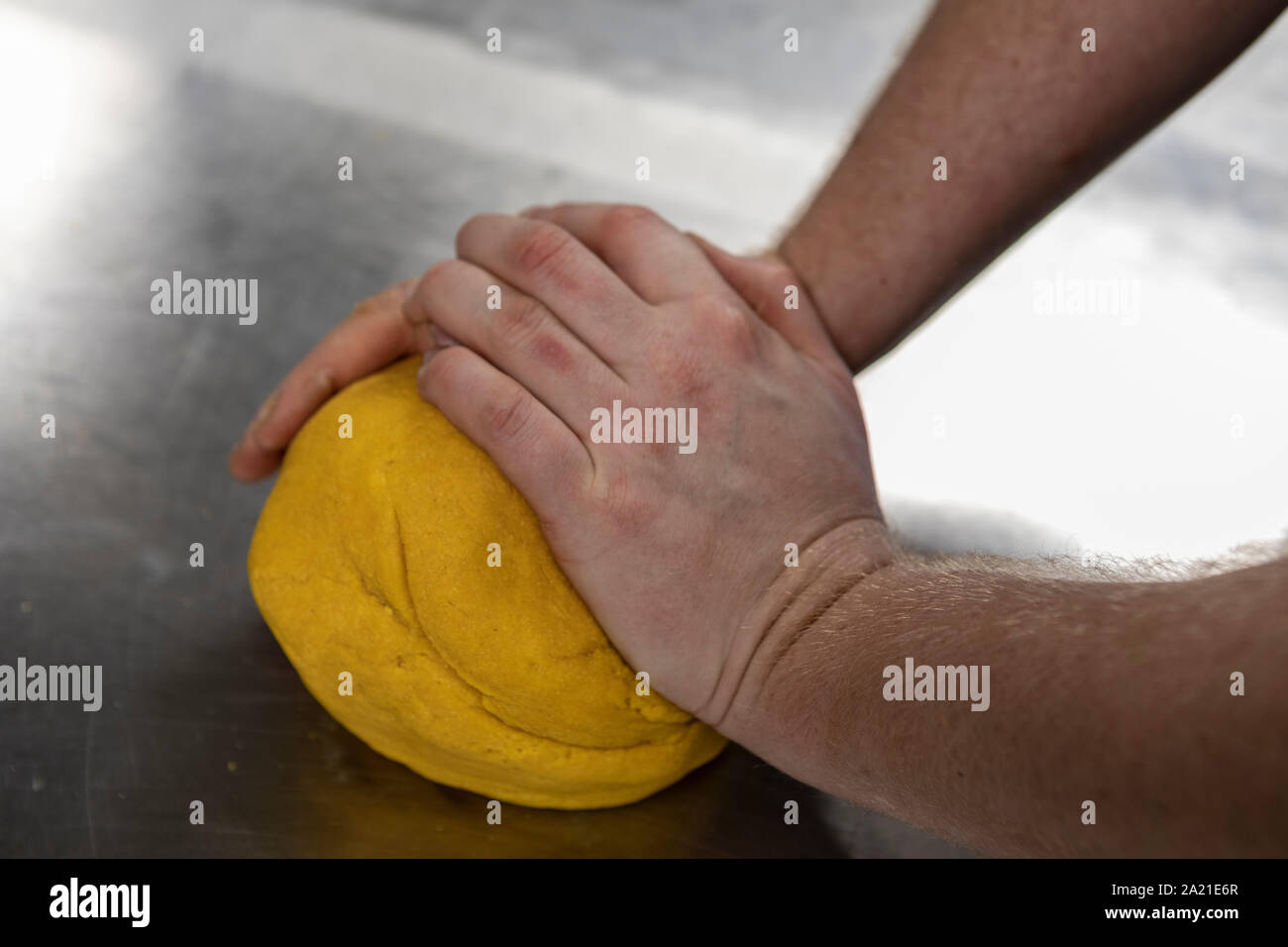Kneading pasta dough ready to be rolled Stock Photo