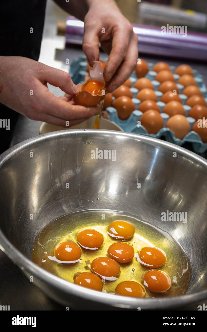 Taking out the yokes from eggs in kitchen Stock Photo