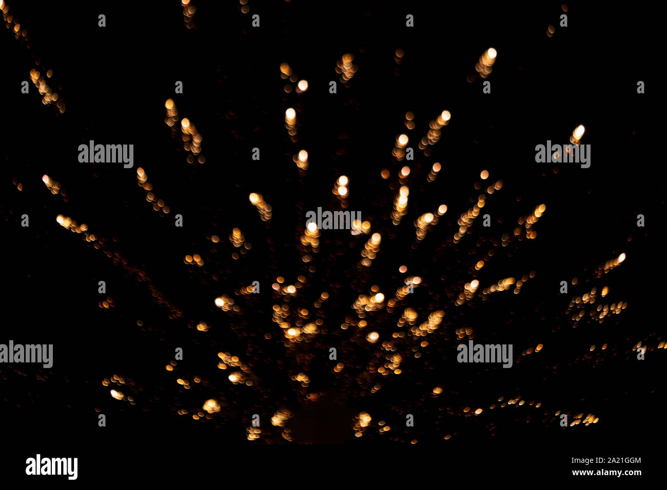 Abstract blurred golden yellow fireworks light up the dark black sky with bokeh background. Concept for diwali, new year, party, 4th july, anniversary Stock Photo