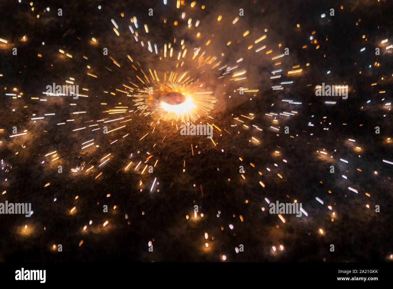 Diwali Firecrackers or crackers also known as chakra or chakri rotating on the ground with fire sparks during Diwali festival in India. Background con Stock Photo