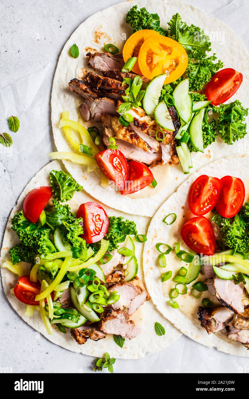 Healthy mini tortillas with grilled chicken, meat, sauce, fresh