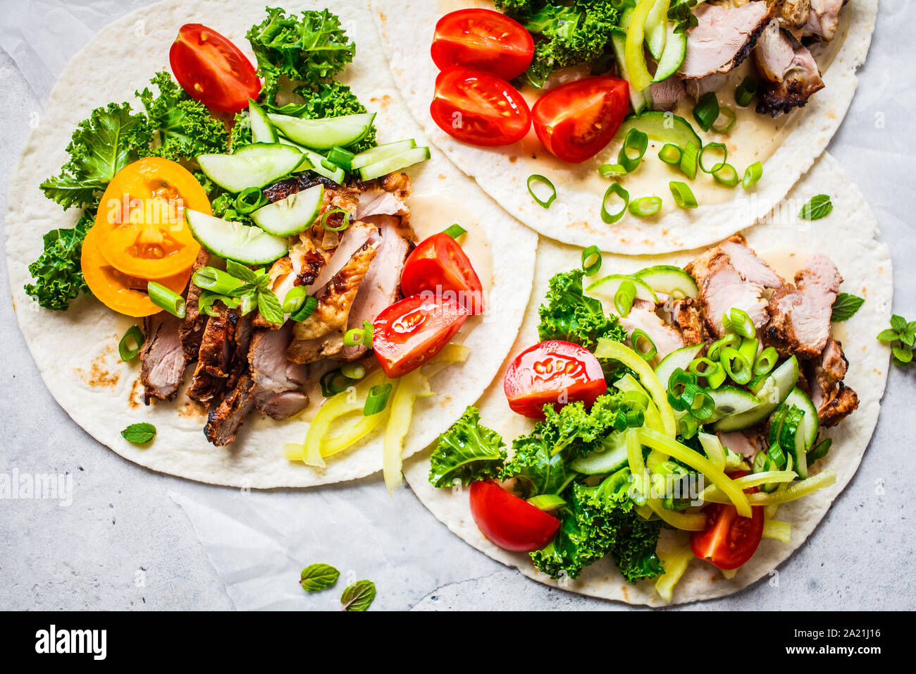 Healthy mini tortillas with grilled chicken, meat, sauce, fresh