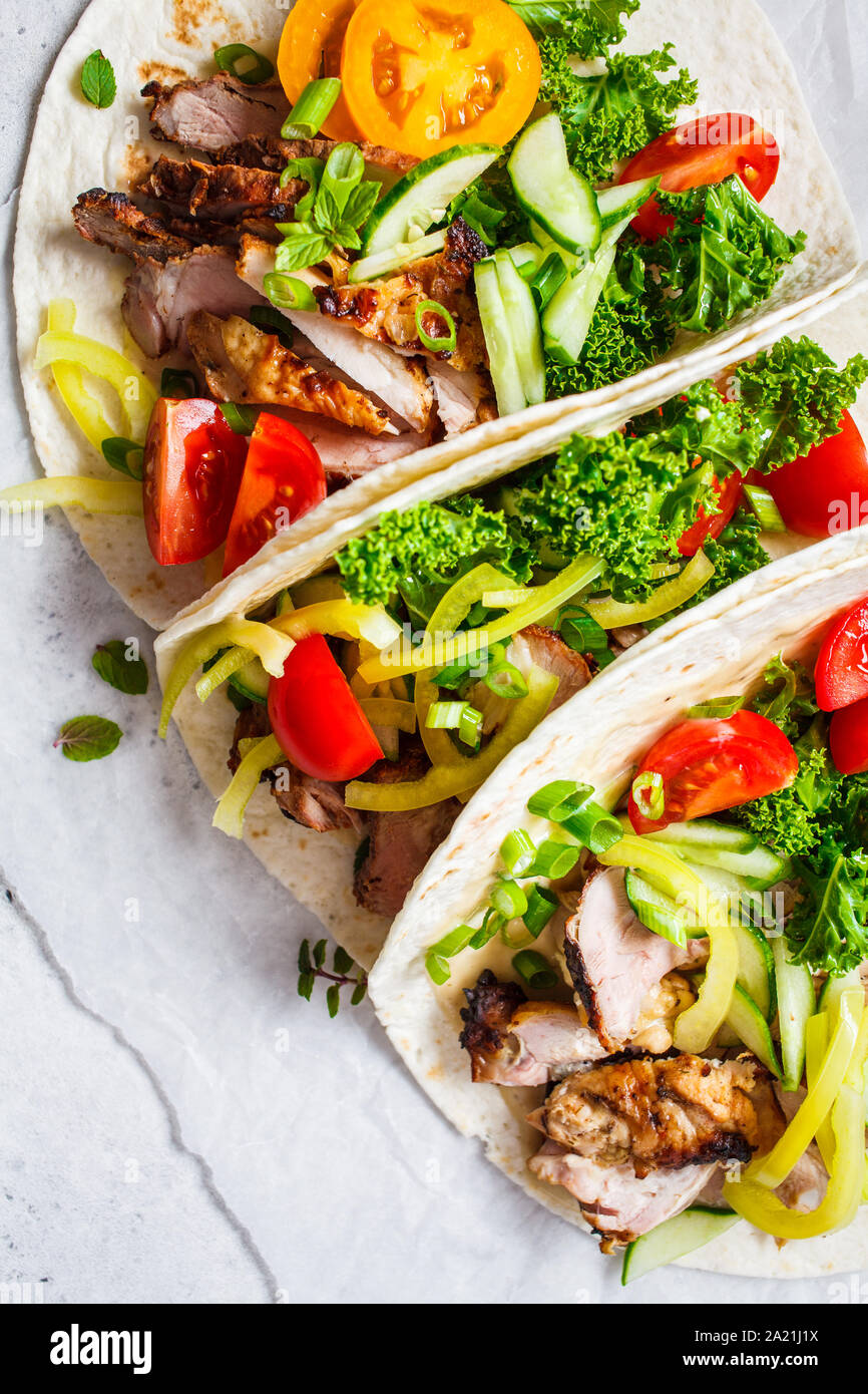 Healthy mini tortillas with grilled chicken, meat, sauce, fresh