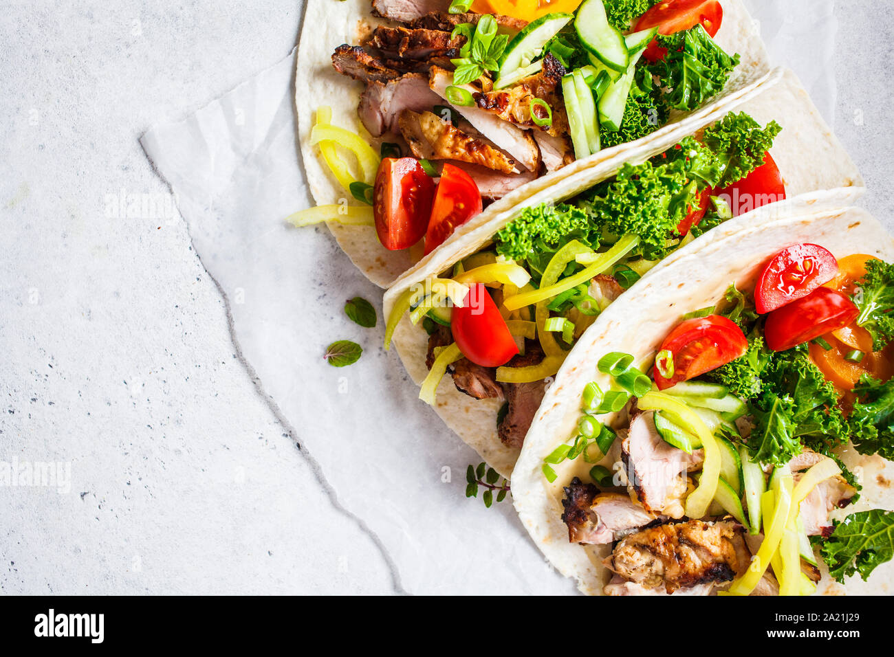 Healthy mini tortillas with grilled chicken, meat, sauce, fresh