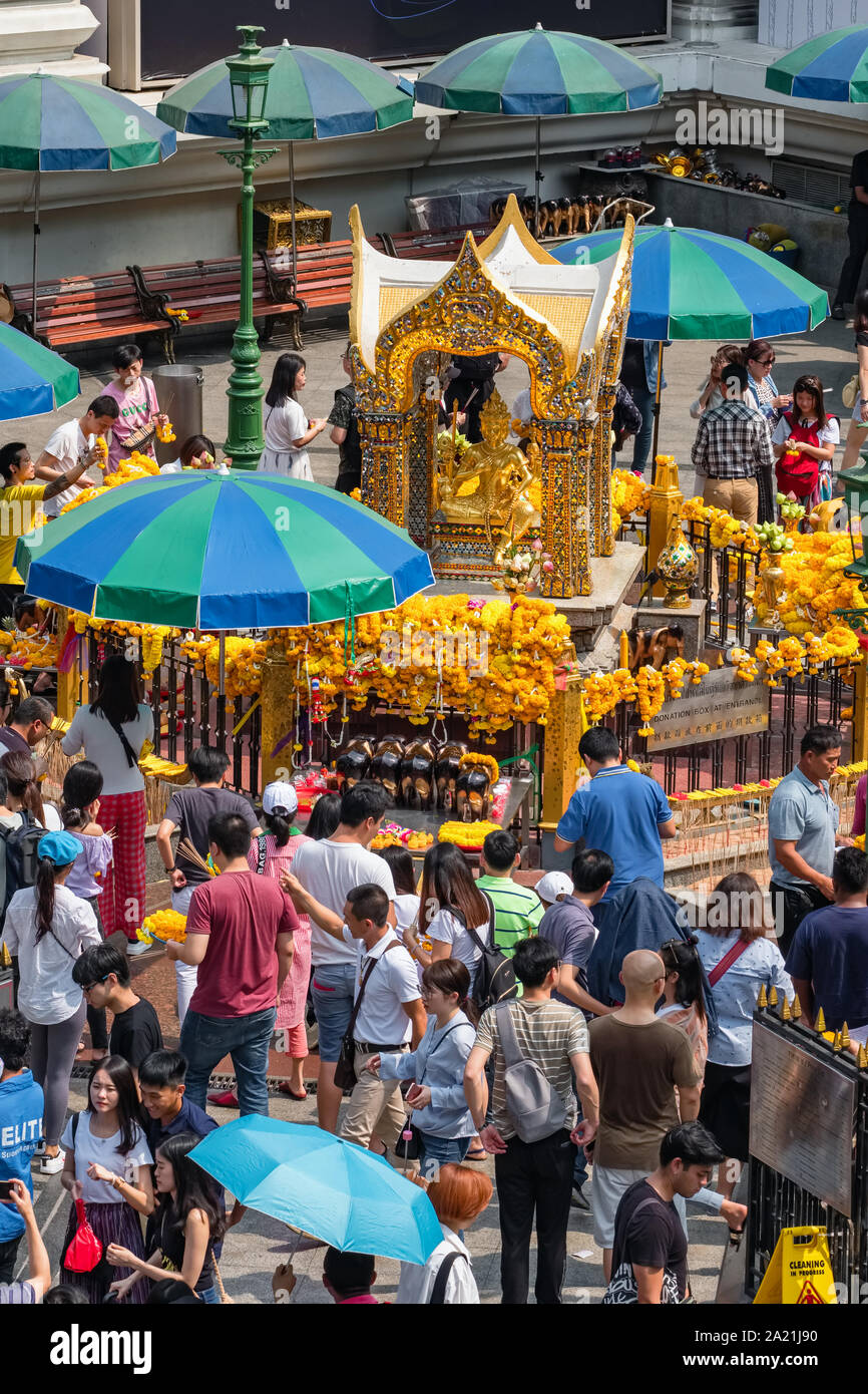 Many people pray respect the famous Erawan shrine at Ratchaprasong Junction in Bangkok capital city,Thailand. Stock Photo