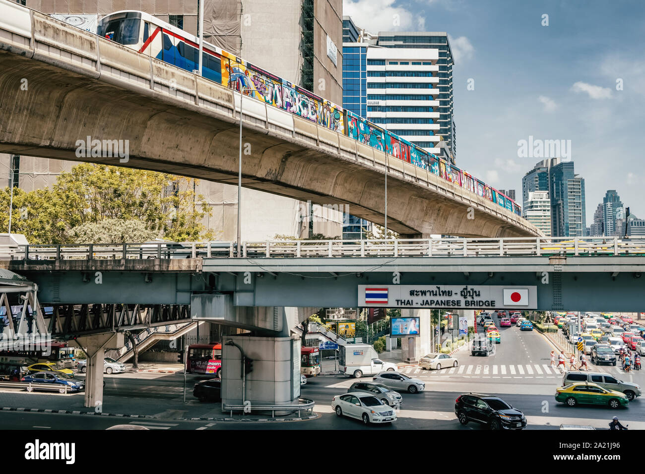 BTS train passing over Thai Japaniese brinde intersection in Bangkok, Thailand. Stock Photo