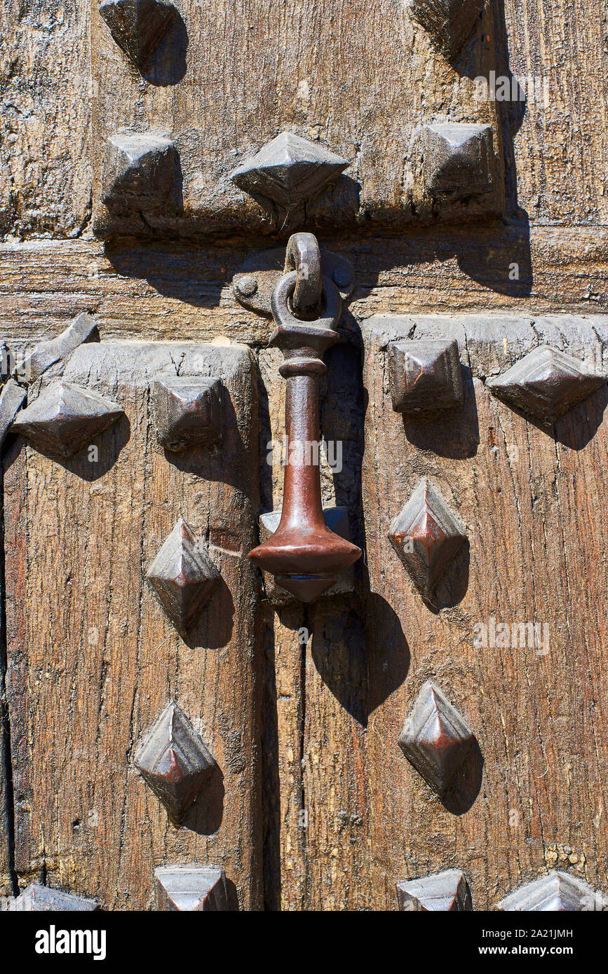 Antique wooden door with a medieval knocker. Stock Photo