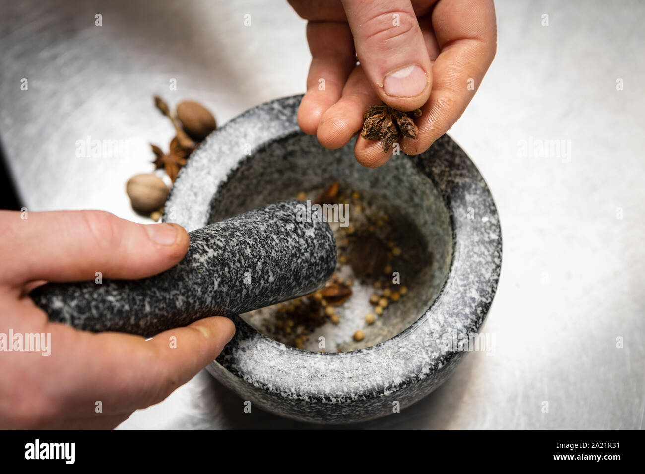 Crushing spices in pestle and mortar in kitchen Stock Photo Alamy
