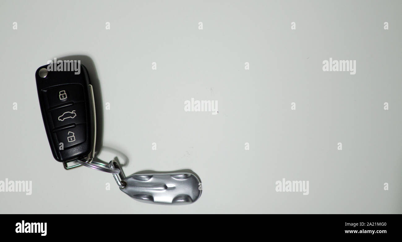 Remote control car key on the left with copy space. White background Stock Photo
