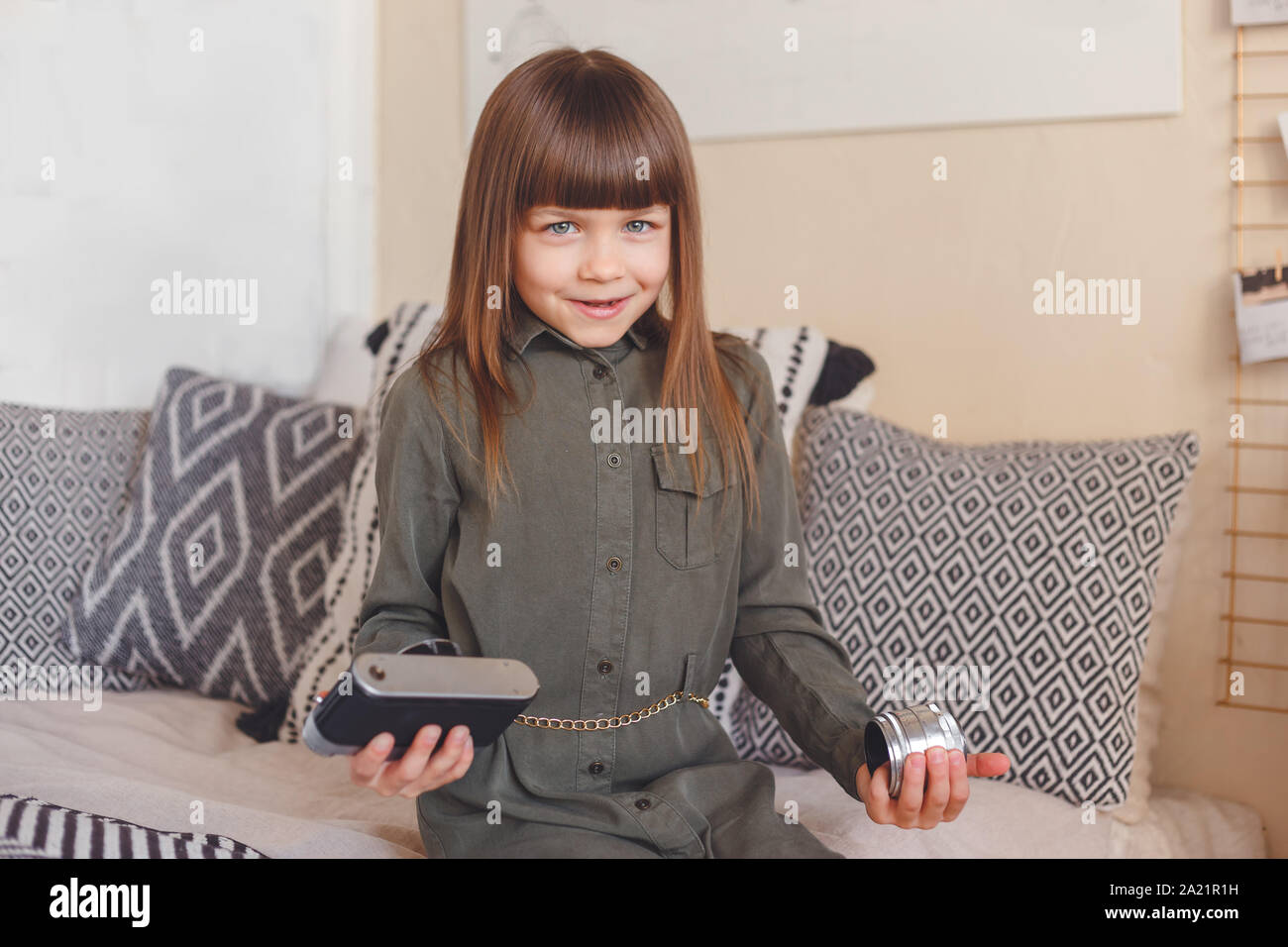 Little confused girl has troubles with camera. Warranty or childhood concept Stock Photo