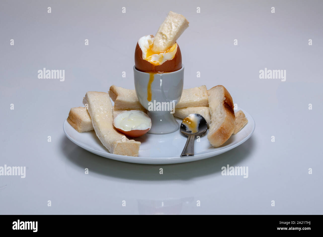 soft boiled chicken's egg, in an egg cup with buttered bread, soldiers ...